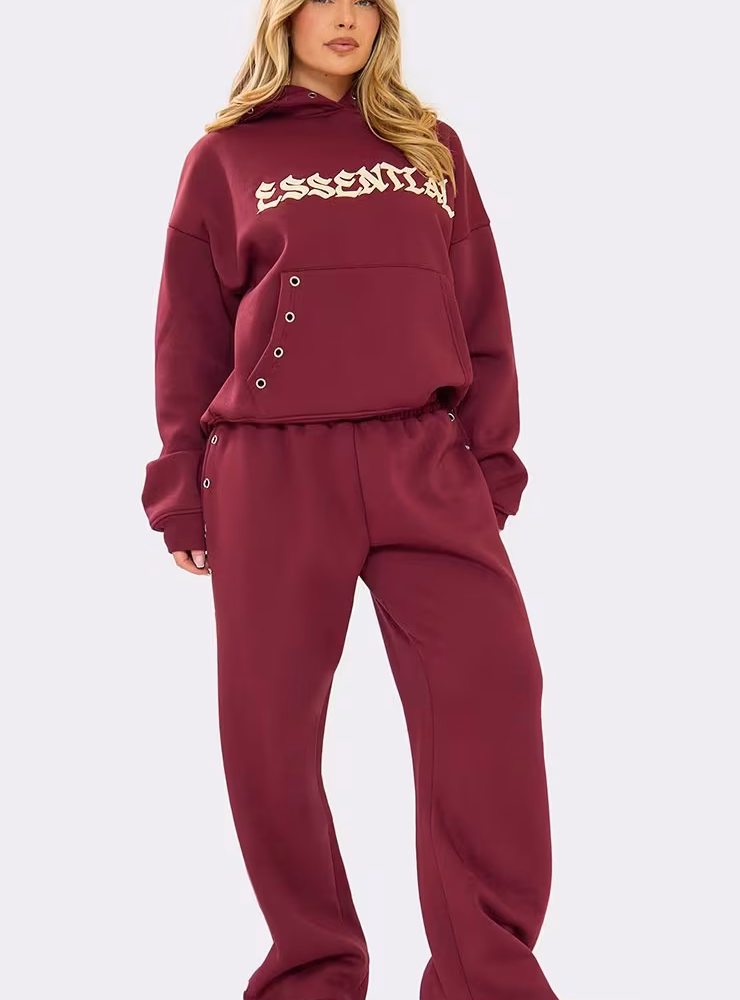 Mid Rise Eyelet Detail Graphic Wide Leg Joggers In Burgundy